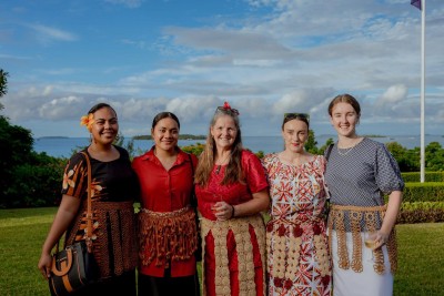 Group of five women smile for the camera